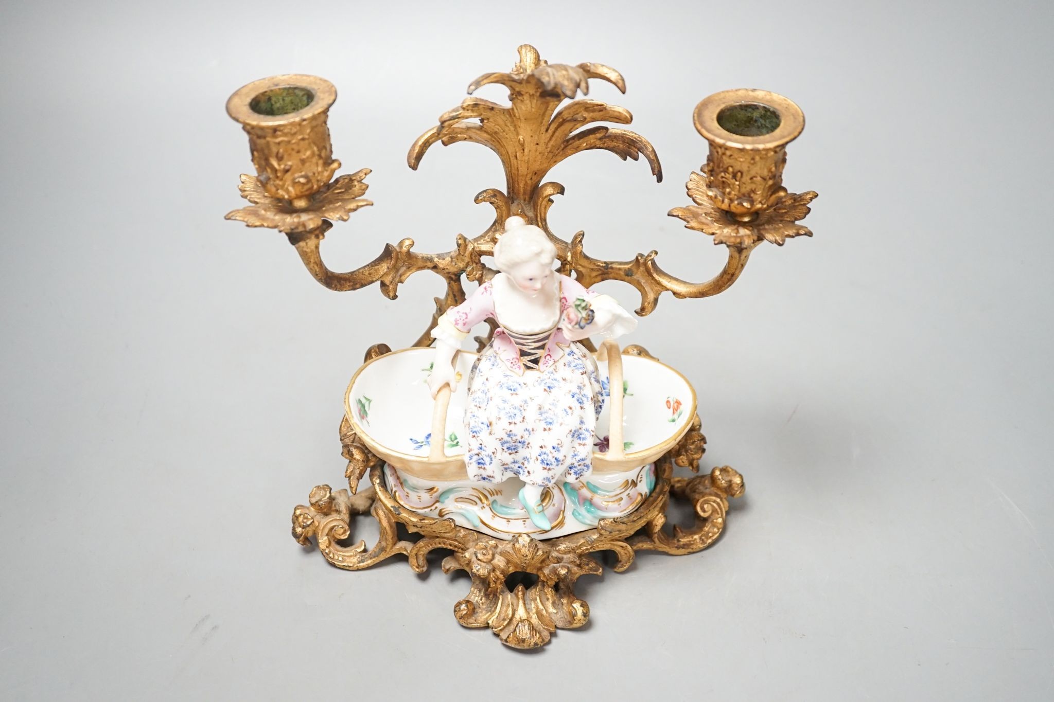 A 19th century Meissen figural salt, incised number 3024, on ormolu candle stand. Total height - 21cm